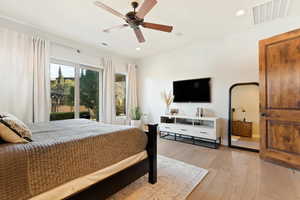 Bedroom with light wood finished floors, visible vents, and recessed lighting