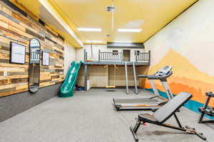 Exercise area featuring wood walls and visible vents