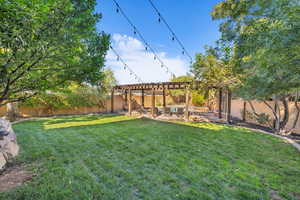 View of yard with a patio area, a fenced backyard, and a pergola