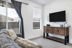 Living room featuring baseboards and light colored carpet