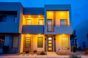 Modern home featuring a balcony and stucco siding