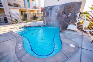 View of pool with fence and a pool