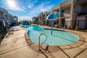 Pool featuring a patio area and fence