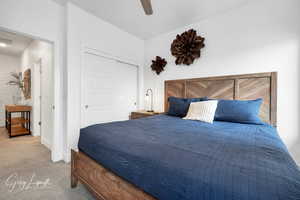 Bedroom featuring a closet, visible vents, a ceiling fan, light carpet, and baseboards