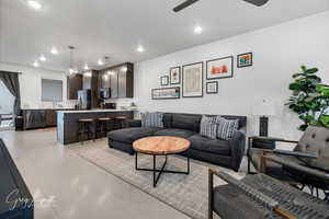 Living room with light tile patterned floors, a ceiling fan, and recessed lighting