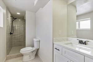 Bathroom with baseboards, vanity, toilet, and walk in shower