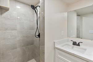 Bathroom with a tile shower and vanity