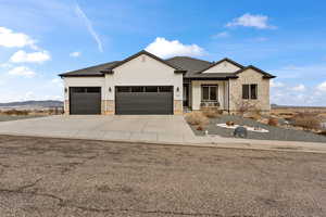 View of front of house featuring concrete driveway, roof with shingles, an attached garage, and a mountain view