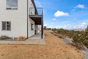 View of yard with a balcony and a patio area