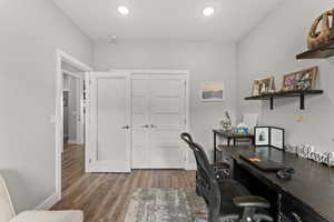 Office with dark wood-style flooring, recessed lighting, and baseboards