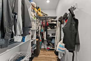 Spacious closet with light wood finished floors