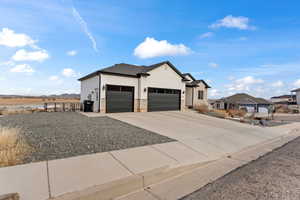 View of front facade featuring a garage, a residential view, concrete driveway, and roof with shingles