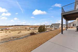 View of yard featuring a patio area and a balcony