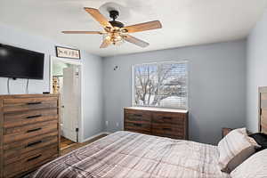 Bedroom featuring a ceiling fan and baseboards