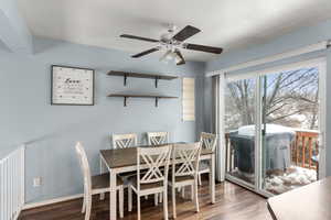 Dining room featuring wood finished floors, a ceiling fan, and baseboards