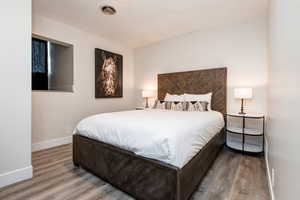 Second bedroom featuring wood finished floors