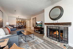 Living area featuring fireplace, entertainment center, dinning table to kitchen