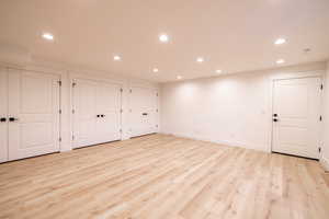 Basement with recessed lighting and light wood-style flooring