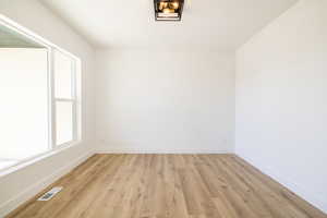 Spare room with light wood-style flooring and baseboards