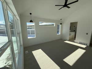 Unfurnished room with high vaulted ceiling, visible vents, and baseboards