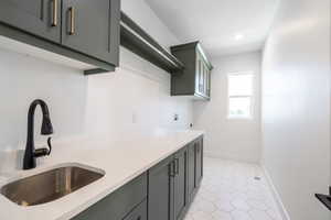 Laundry room featuring cabinet space, hookup for an electric dryer, washer hookup, and recessed lighting