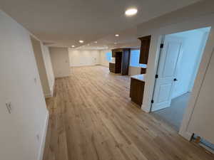 Below grade area featuring recessed lighting, baseboards, and light wood finished floors