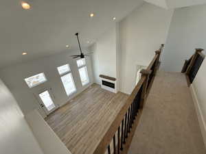 Interior space with recessed lighting, light wood-style flooring, ceiling fan, high vaulted ceiling, and baseboards