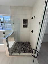 Full bathroom with a stall shower and a bath