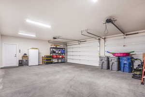 Garage featuring freestanding refrigerator