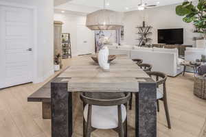 Dining room featuring a ceiling fan, light wood-type flooring, baseboards, and recessed lighting