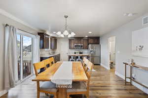 Dining area featuring recessed lighting, visible vents, an inviting chandelier, light wood-type flooring, and baseboards