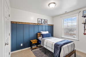 Bedroom with a textured ceiling, carpet, visible vents, and baseboards