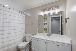 Full bathroom with toilet and vanity