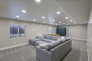 Living area featuring recessed lighting, baseboards, and light colored carpet