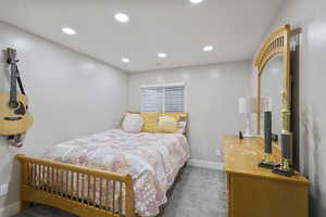 Carpeted bedroom with baseboards, visible vents, and recessed lighting