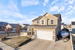 Traditional-style house with a garage, concrete driveway, a residential view, fence, and stucco siding