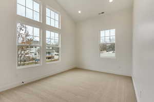 Unfurnished room featuring baseboards, recessed lighting, visible vents, and light colored carpet