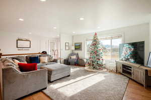 Living room with recessed lighting and light wood-style floors