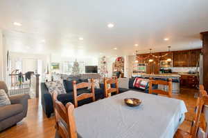 Dining space featuring light wood-style flooring and recessed lighting