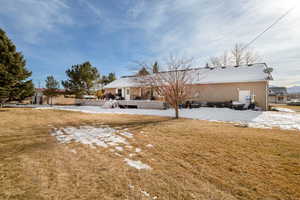 Back of property featuring a lawn