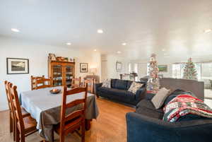 Dining area with recessed lighting and light wood finished floors