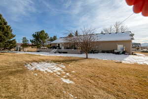 Rear view of property featuring a yard