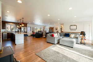 Living area with light wood-style floors and recessed lighting