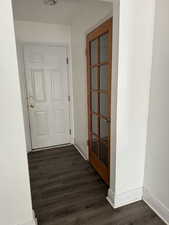 Hallway with dark wood-type flooring