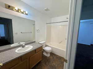 Full bathroom featuring bathtub / shower combination, vanity, and toilet