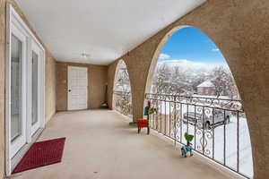 View of snow covered back of property