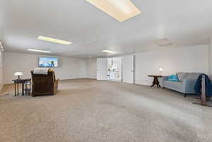 Sitting room featuring carpet floors and a textured ceiling