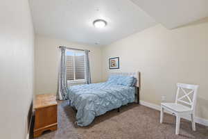 Bedroom with carpet floors and baseboards