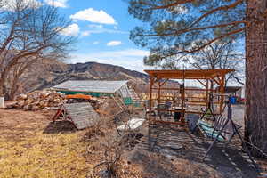 View of yard with an outdoor structure, an exterior structure, and a mountain view