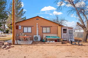 Rear view of property featuring a patio, ac unit, and fence